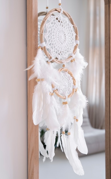 Free photo dreamcatcher hanging from a mirror