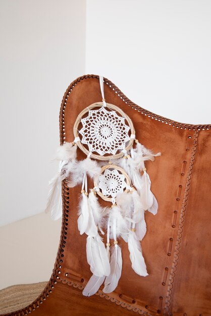 Dreamcatcher placed on the backrest of a leather chair