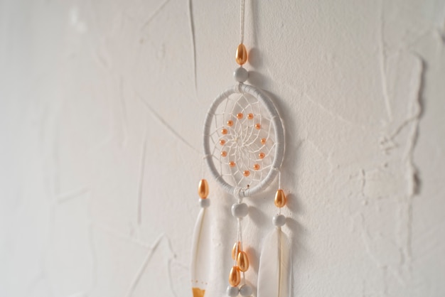 Free photo dreamcatcher placed on a white wall