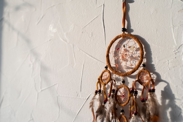 Free photo dreamcatcher placed on a white wall