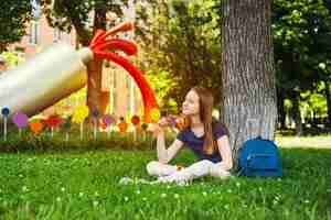 Free photo dreaming student on lawn