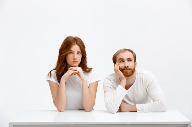 Dreamy adult man and serious woman redheads