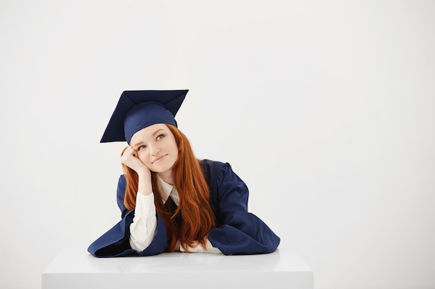 Dreamy beautiful woman graduate smiling thinking. 