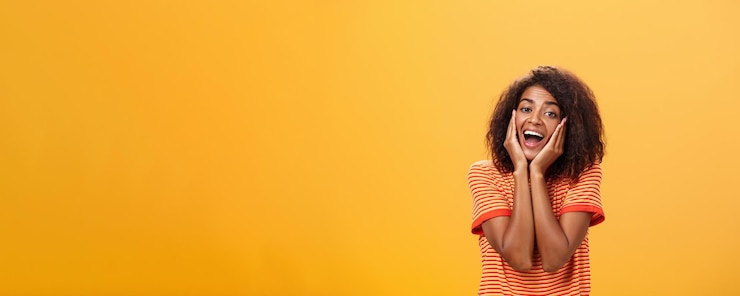 Free Photo dreamy goodlooking stylish young african female with curly hairstyle sighing leaning head on palms g