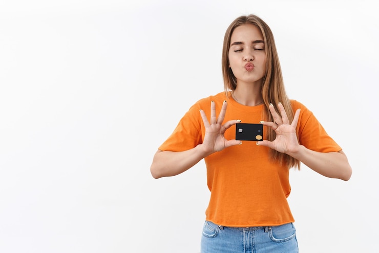 Free Photo dreamy happy, blonde fashionable girl shopaholic likes shopping online, adores her credit card