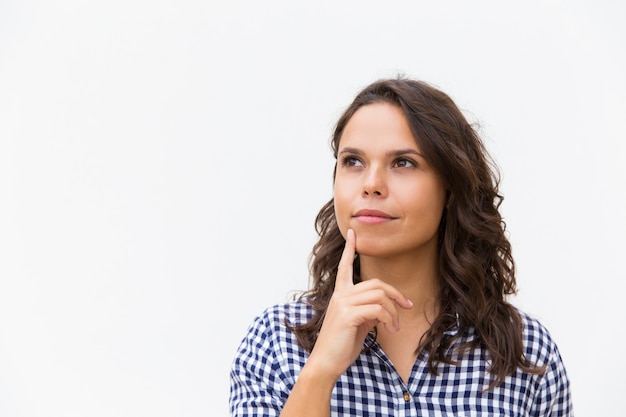 Girl thinking while touching her chin