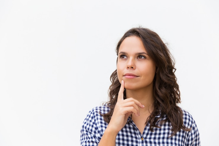 Free Photo dreamy pensive female customer touching chin