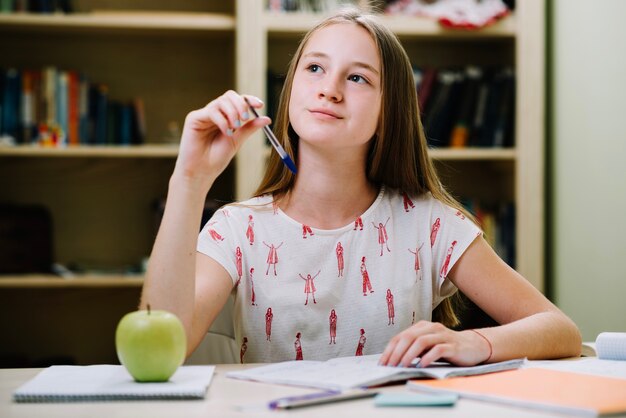 Dreamy studying teen girl