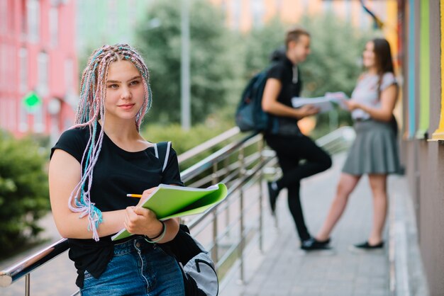 Dreamy teen girl with textbook