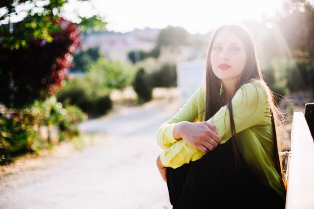 Dreamy woman looking away in park