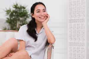 Free photo dreamy woman in pijama on couch