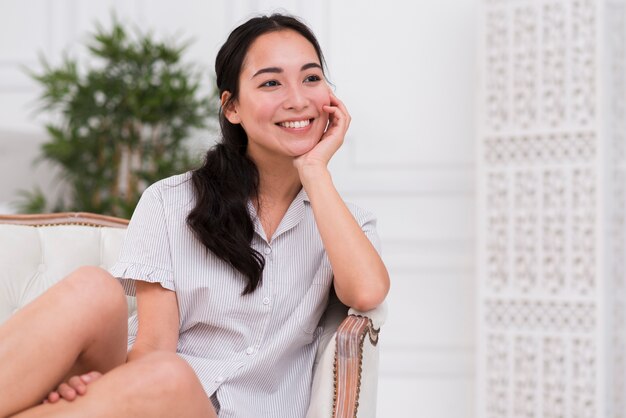 Dreamy woman in pijama on couch