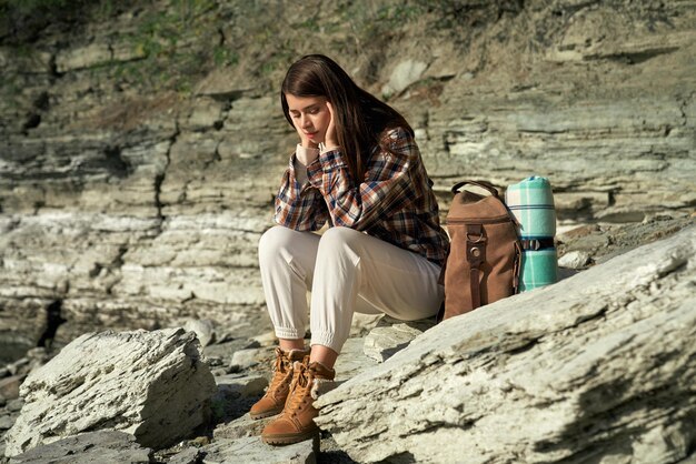 Dreamy woman relaxing on rock at Bakota area