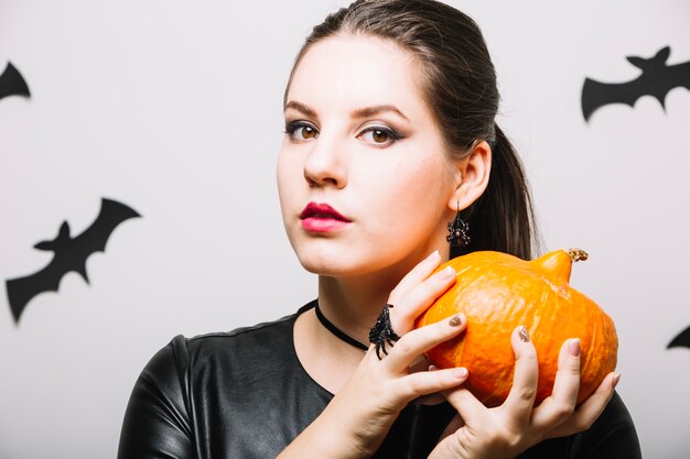 Dreamy woman with small pumpkin