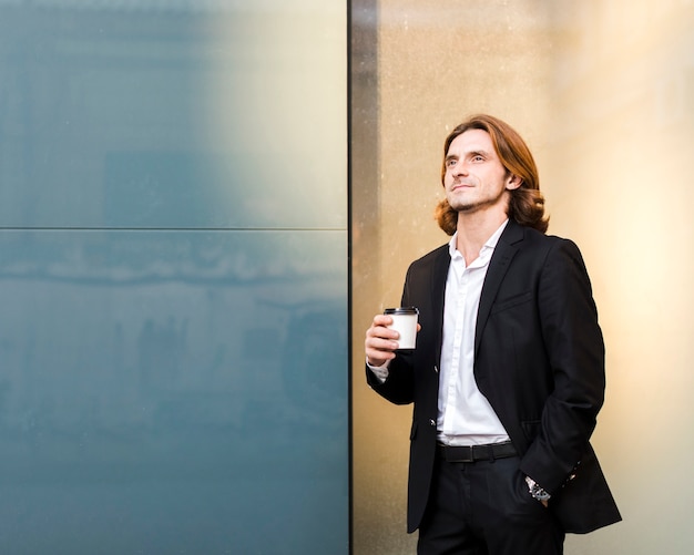 Free photo dreamy young man in elegant suit