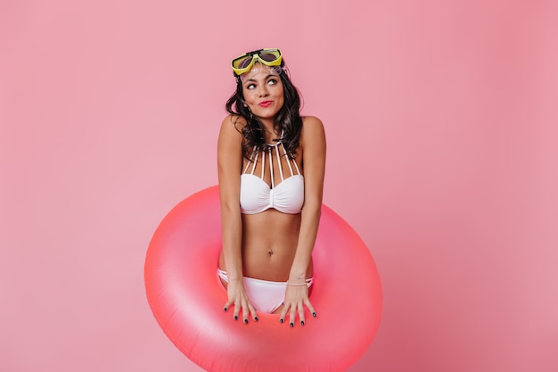 Free photo dreamy young woman in goggles looking up