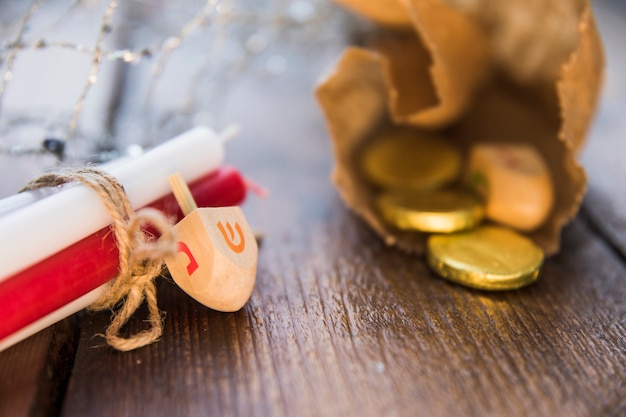 Dreidel and candles near gelt