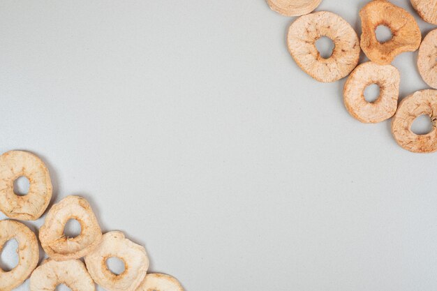 Dried apple chips on gray surface