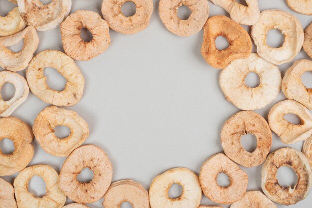 Dried apple rings on gray surface
