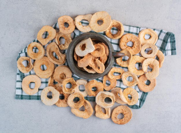 Dried apples slices in a metallic pot.