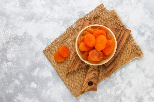 Dried apricots on light concrete 