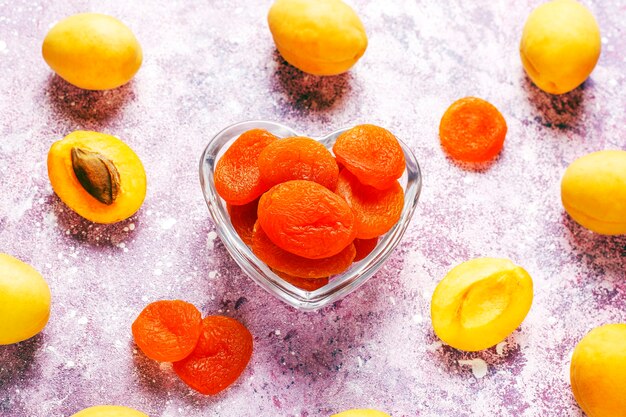 Dried apricots with fresh juicy apricot fruits, top view