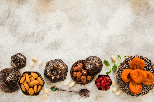 Free photo dried apricots with nuts on table