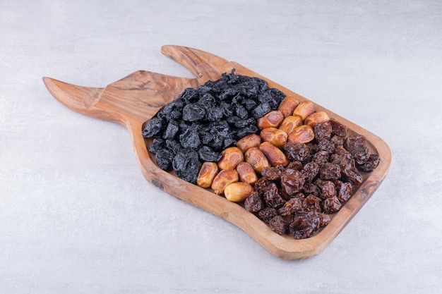 Dried cherries, berries and dates on a wooden platter. High quality photo