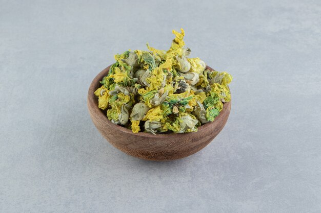 Dried chrysanthemum flowers in wooden bowl. 