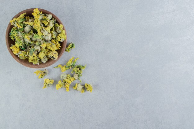 Dried chrysanthemum flowers in wooden bowl