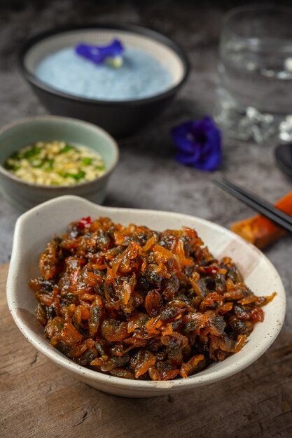 Dried clams, served with three flavored sauce served with steamed rice Asian Seafood Concept.