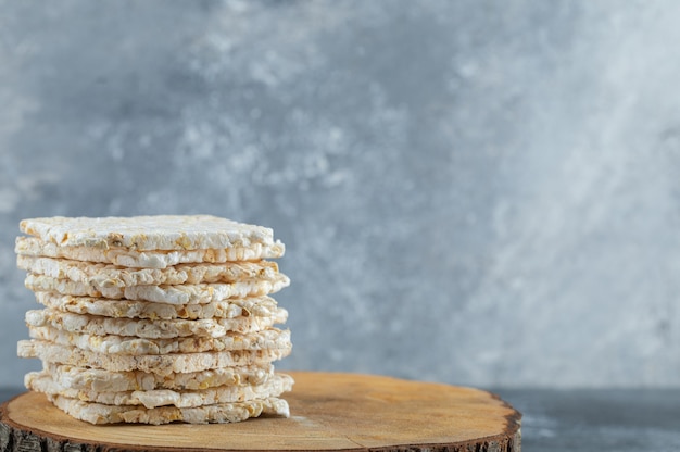 Dried diet crispy rice round bread isolated on wood piece.