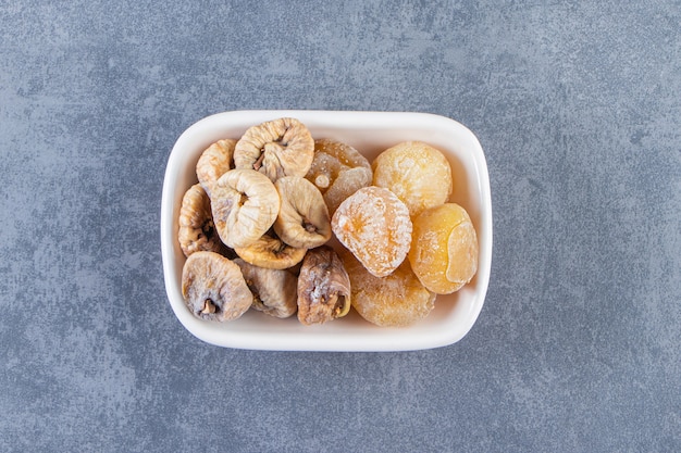 Dried figs in a bowl , on the marble background.