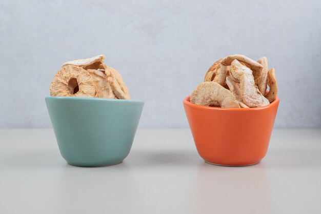 Dried fruit slices in colorful bowls