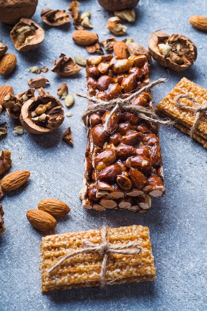 Dried fruits bar tied with string on concrete backdrop