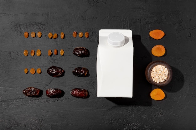 Free photo dried fruits and carton milk arrangement