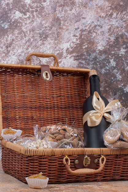 Dried fruits and nuts packed in plastic bags with wooden bag.