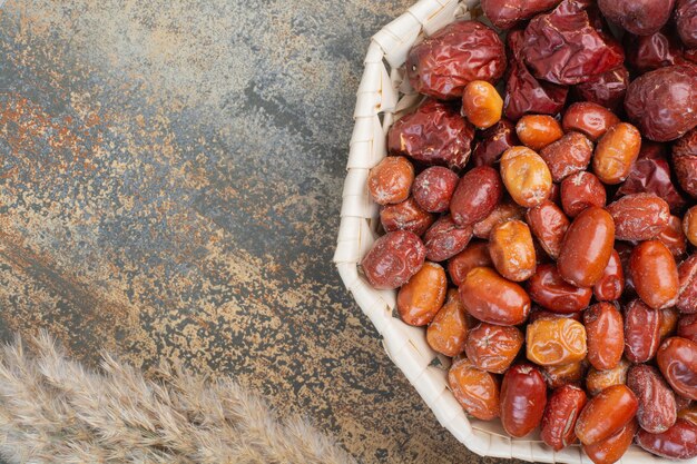 Dried fruits in white bowl on marble background.High quality photo