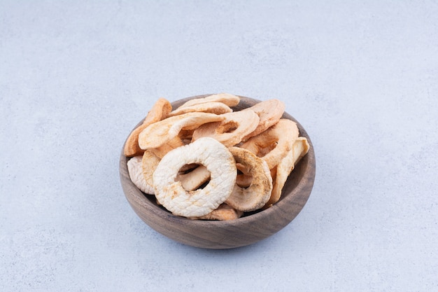 Dried healthy apples on wooden plate. 