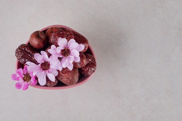 Dried indian jujube berries in a ceramic cup.