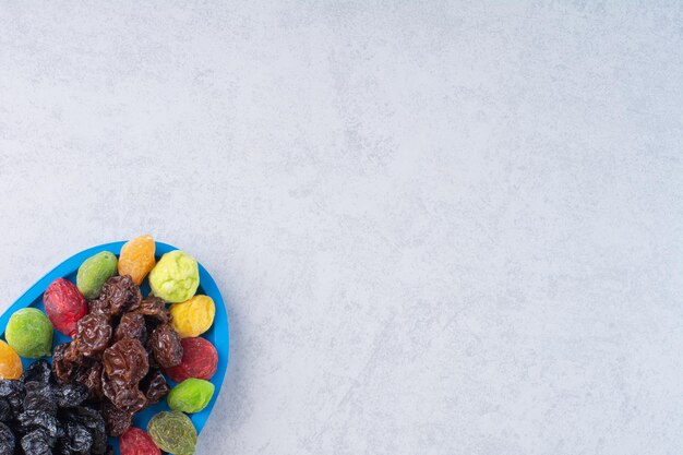 Dried multicolor cherries and berries on concrete background.