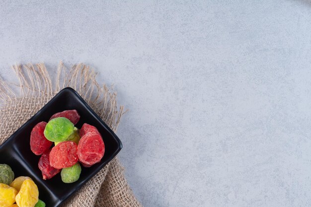 Dried multicolor cherries and berries on concrete background.