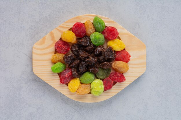 Dried multicolor fruit jellies isolated on concrete surface.