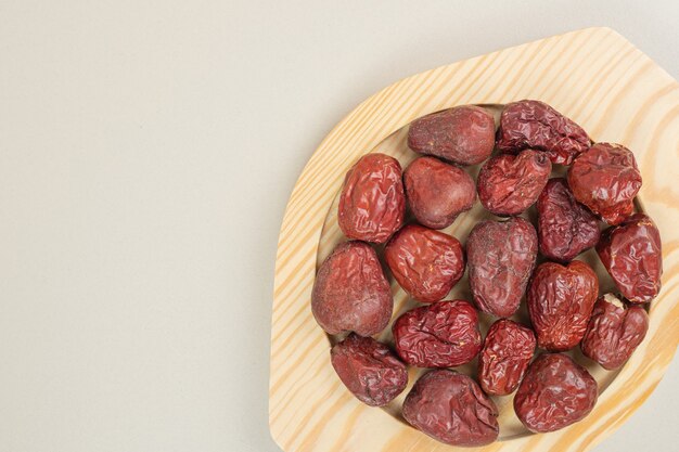 Dried oleaster fruits on wooden plate