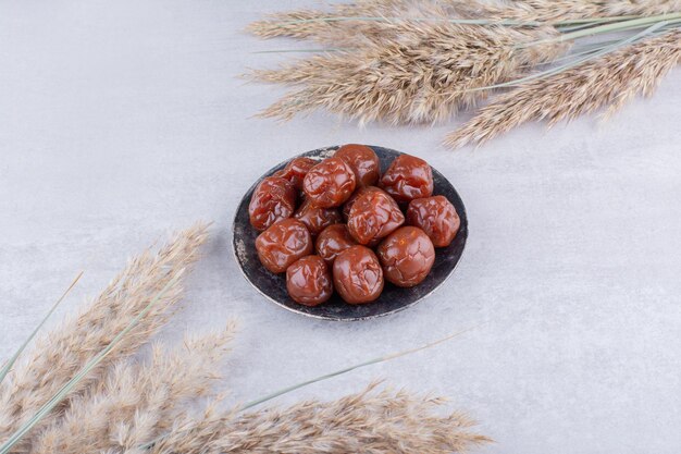 Dried plum cherries in a cup on concrete background. High quality photo