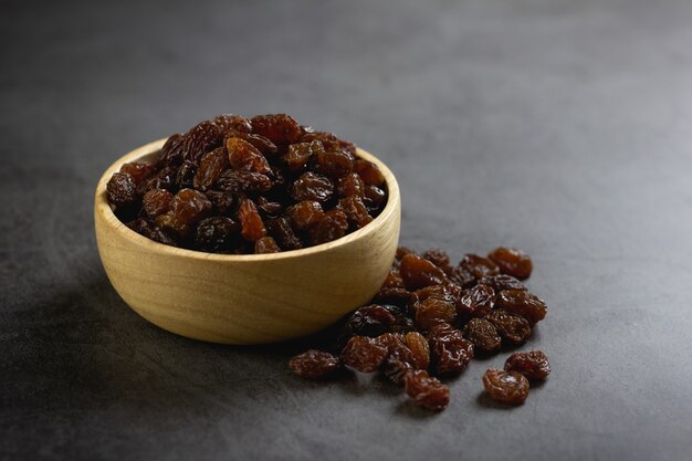 Dried raisins in bowl on table