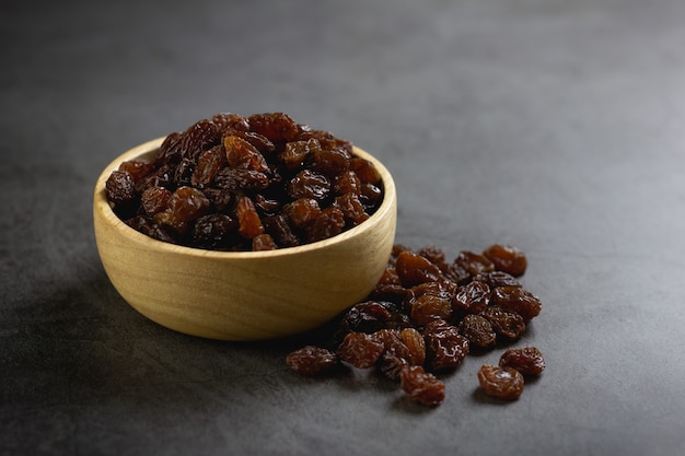 Dried raisins in bowl on table