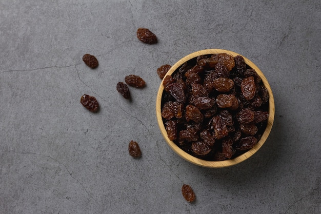 Dried raisins in bowl on table