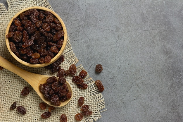 Dried raisins in bowl on table