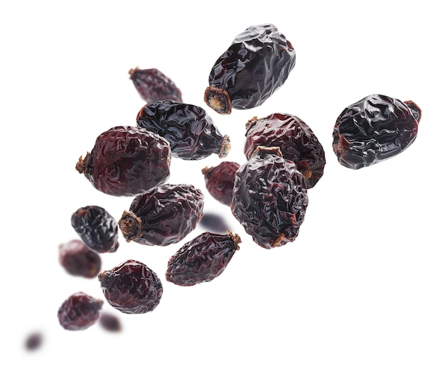 Dried rosehip berries levitate on a white background